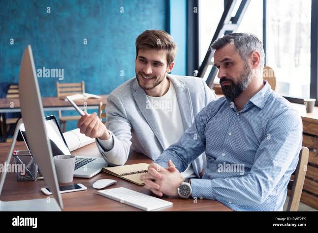 two men sitting in office